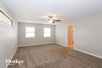 Plano house for rent - a living room with carpet and a ceiling fan