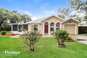 Deltona house for rent - the front of a house with a lawn and two trees