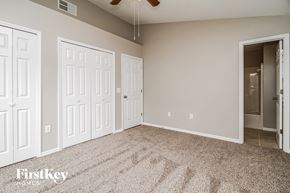 Deltona house for rent - a bedroom with two closets and a carpeted floor
