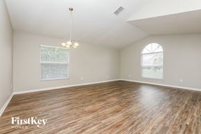 Orlando house for rent - the spacious living room with wood flooring and a large window