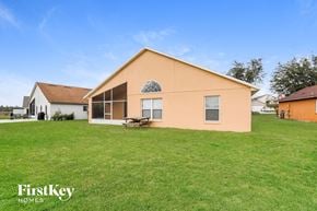 Orlando house for rent - a house with a grass yard and a picnic table