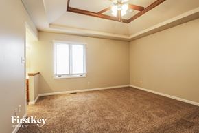 Indianapolis house for rent - a empty living room with a ceiling fan and a window