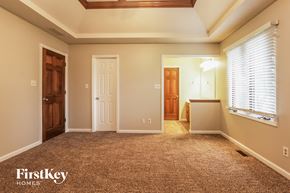 Indianapolis house for rent - a room with a carpeted floor and a door and a window