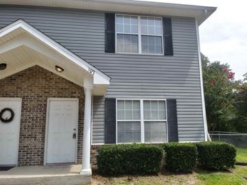 Tallahassee apartment for rent - A house with a grey siding and a white door.