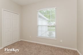 Jacksonville house for rent - a bedroom with a window and a white door