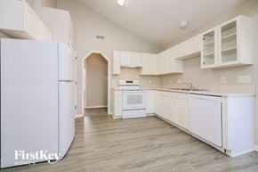 Knightdale house for rent - a white kitchen with white appliances and white cabinets