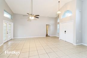 Palm Bay house for rent - A spacious room with a ceiling fan and tiled flooring.