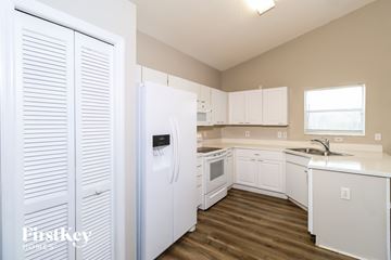 Palm Bay house for rent - A kitchen with white appliances and cabinets.