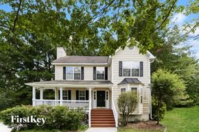 Snellville house for rent - A two-story house with a porch and a tree in front.