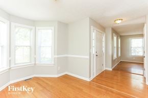 Snellville house for rent - A room with wooden floors and white walls.