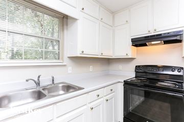 Snellville house for rent - A black oven is built into a white kitchen counter.