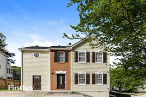 Marietta house for rent - A two-story house with a beige exterior and a brown door.