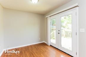 Marietta house for rent - A room with a wooden floor and a sliding glass door leading to a balcony.