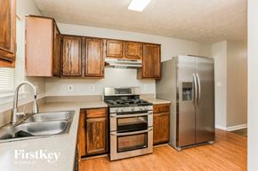 Marietta house for rent - A kitchen with wooden cabinets and stainless steel appliances.