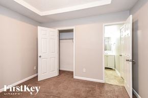 Ellenwood house for rent - a bedroom with a closet and a door to a bathroom