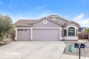 Tucson house for rent - a house with a driveway and a garage door