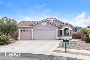Tucson house for rent - a house with a driveway and a garage door