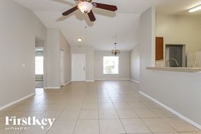 Port St Lucie house for rent - an empty kitchen and living room with a ceiling fan