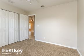 Port St Lucie house for rent - a bedroom with two closets and a carpeted floor