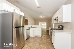 Jacksonville house for rent - a white kitchen with stainless steel appliances and white cabinets