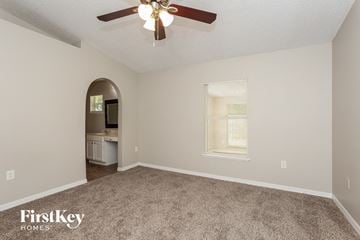Jacksonville house for rent - a living room with carpet and a ceiling fan