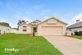 Winter Haven house for rent - A house with a garage and a driveway is for sale.