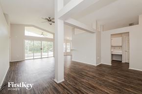 Winter Haven house for rent - A spacious room with wooden floors and white walls, part of a house by FirstKey Homes.