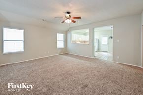 Spring house for rent - A spacious room with a carpeted floor and a ceiling fan.