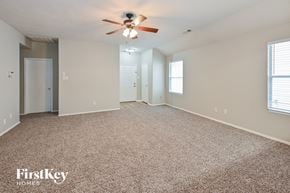 Spring house for rent - A spacious room with a ceiling fan and carpeted floor.