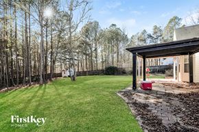 Covington house for rent - a backyard with a grassy lawn and a shed