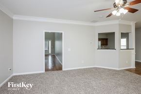 Ball Ground house for rent - a empty living room with a ceiling fan and a carpet