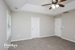 Ball Ground house for rent - the master bedroom has a ceiling fan and a carpeted floor
