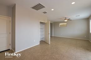 Vail house for rent - A spacious room with a ceiling fan and a door leading to another room.