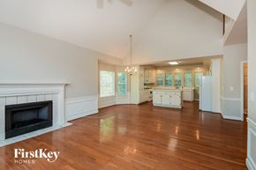 Douglasville house for rent - a large living room with a fireplace and a wooden floor