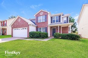 Jackson house for rent - A house with a red brick facade and a white garage door is for sale.