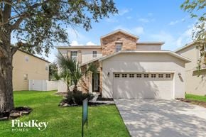 Riverview house for rent - a house with a garage and a driveway and a tree