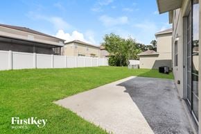 Riverview house for rent - the yard of a house with a driveway and grass