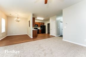 Lawrenceville house for rent - A spacious living room with a kitchen in the background.