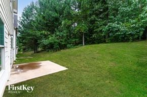 Lawrenceville house for rent - A backyard with a lawn and trees.