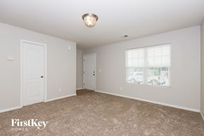 Charlotte house for rent - A room with a carpeted floor and a window with blinds.