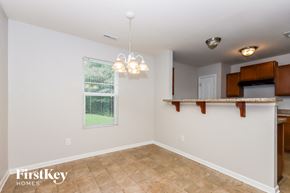 Charlotte house for rent - A well-lit room with a window, a chandelier, and a countertop.