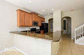 Orlando house for rent - a kitchen with a granite counter top and