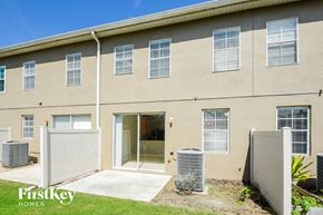 Orlando house for rent - the front of a building with a driveway and a backdoor