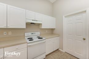 Lehigh Acres house for rent - a white kitchen with white appliances and white cabinets