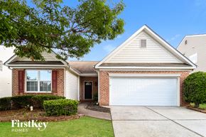 Lawrenceville house for rent - a brick house with a white garage door