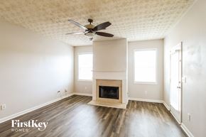 Lawrenceville house for rent - a living room with a fireplace and a ceiling fan