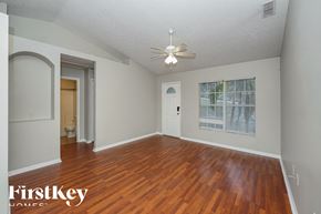 Orange City house for rent - a living room with wood floors and a ceiling fan