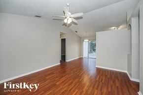Orange City house for rent - the living room and dining room with hardwood flooring and a ceiling fan