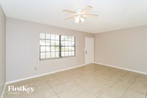 Palm Bay house for rent - A room with a ceiling fan and a window.