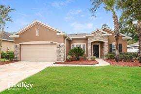 Jacksonville house for rent - A house with a garage and a driveway in front of it.